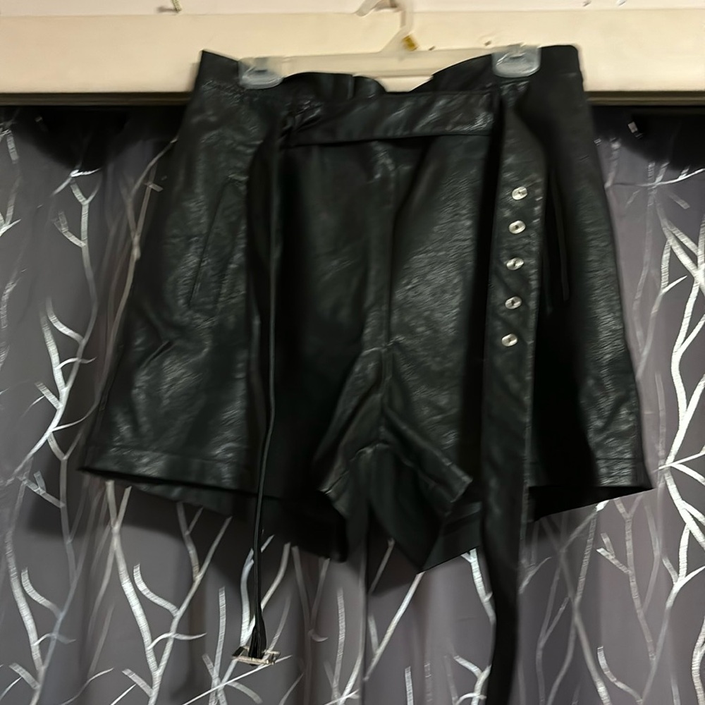 Black faux leather shorts with belt zipper in the back